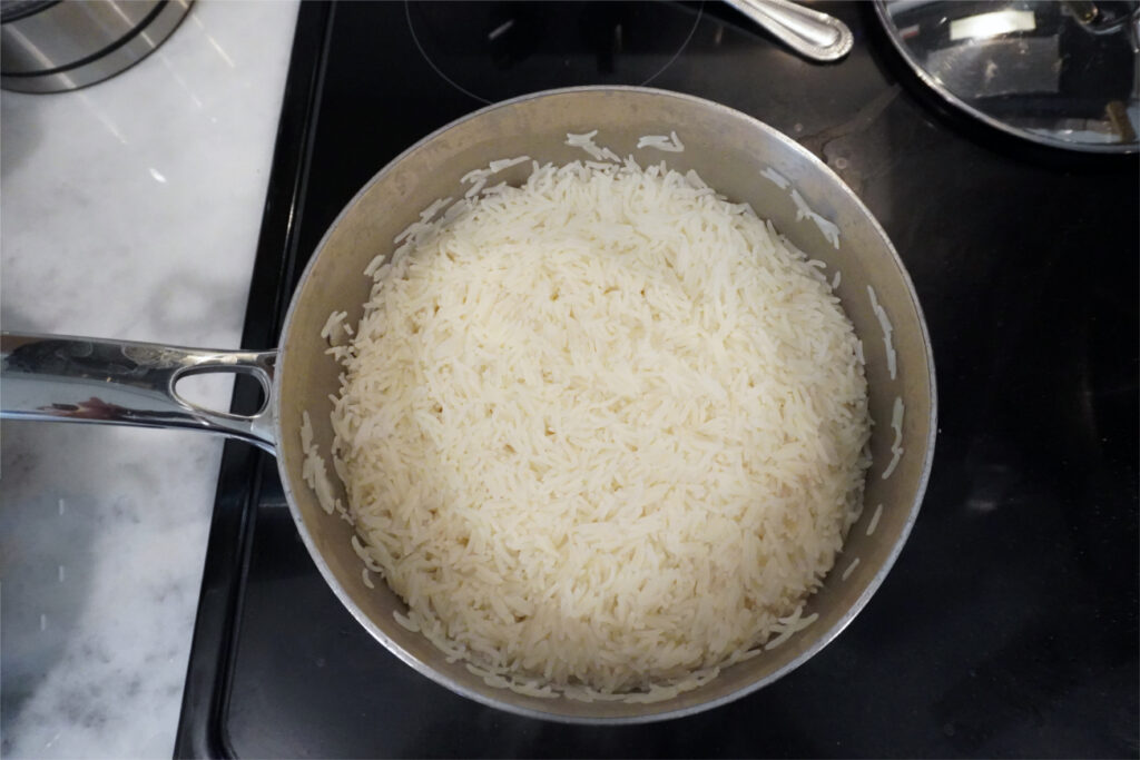 a pot of cooked rice on the stove