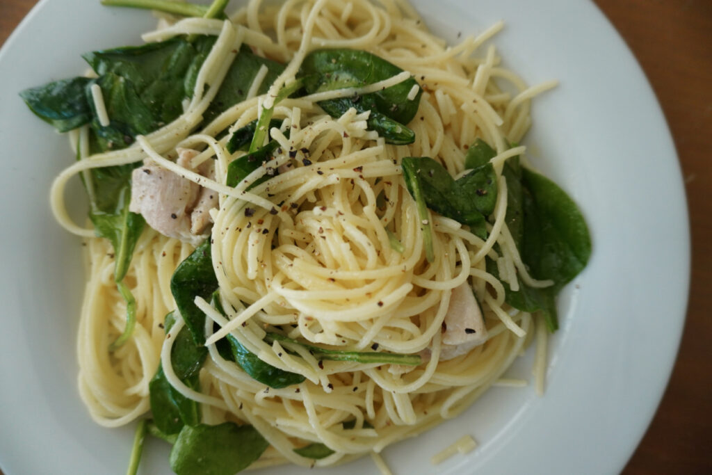lemon chicken pasta swirled on a white plate
