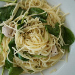Lemon chicken pasta swirled on a white plate