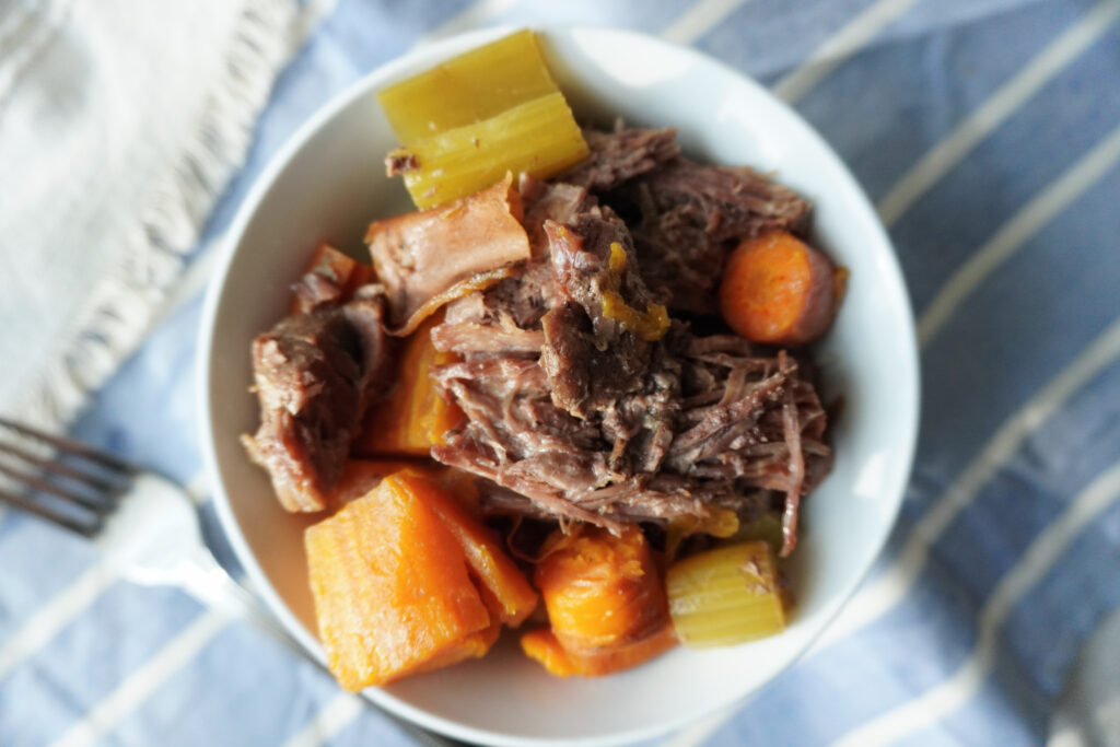 bowl of pot roast with sweet potatoes over rice