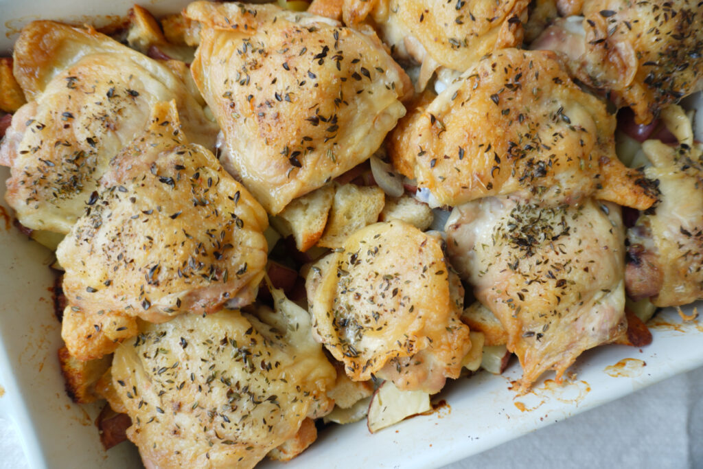 a baking dish of golden crispy baked chicken thighs