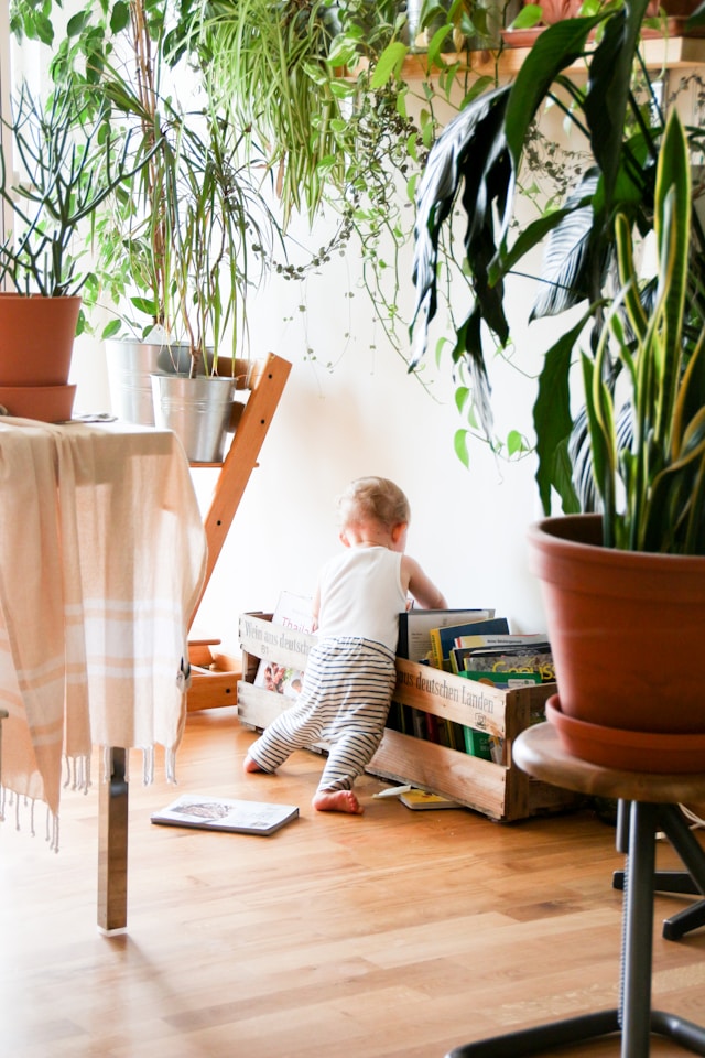 baby rummaging through a basket of books