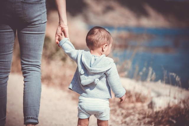 woman walking with a toddler