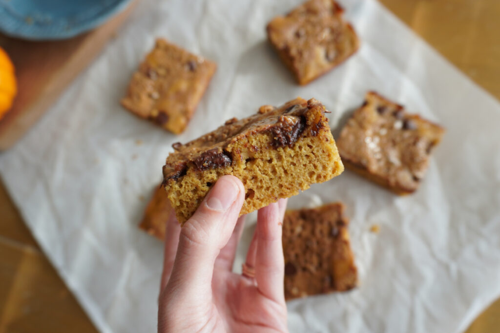 hand holding a fudgy almond butter pumpkin bar