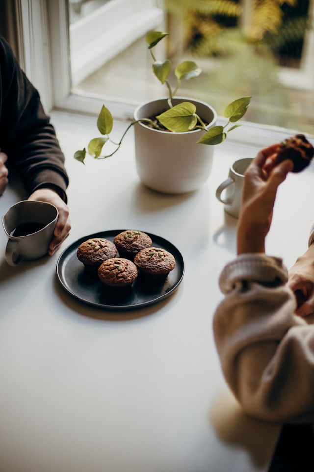 a couple enjoying coffee and chocolate muffins